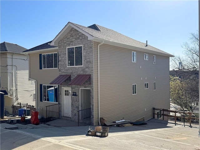 rear view of house with stone siding