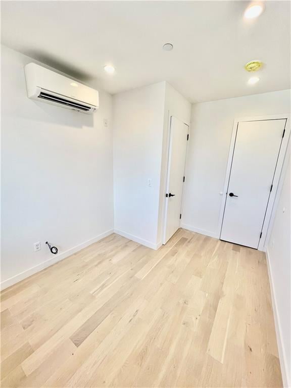 800 5th Ave Unit 4A, Brooklyn, NY 11232 - empty room with baseboards, recessed lighting, light wood-style floors, and a wall mounted air conditioner