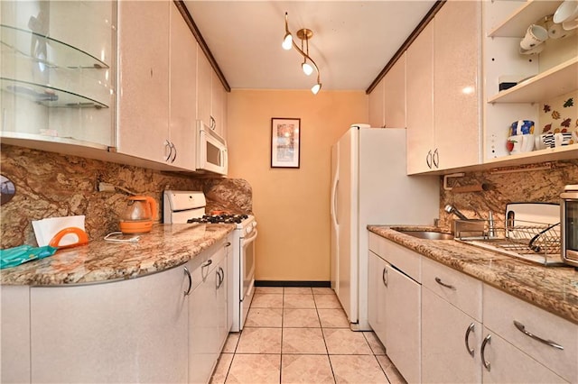 kitchen with tasteful backsplash, light tile patterned floors, open shelves, a sink, and white appliances