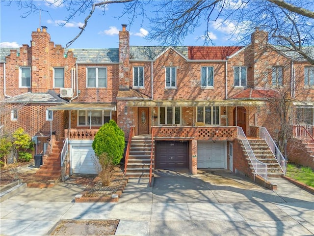 2213 E 26th St, Brooklyn, NY 11229 - view of property featuring stairs, covered porch, driveway, and brick siding