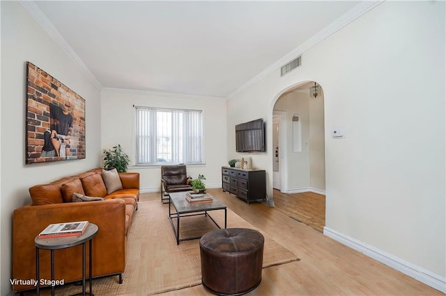 2567 E 6th St, Brooklyn, NY 11235 - living area featuring ornamental molding, arched walkways, light wood finished floors, and baseboards