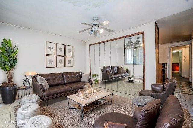 living area featuring tile patterned flooring and ceiling fan