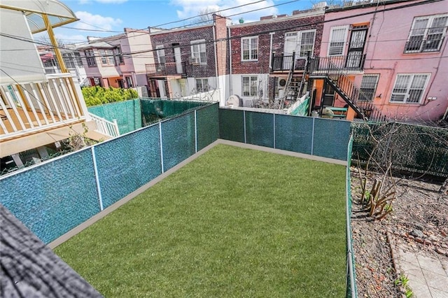 view of sport court with a yard and a fenced backyard