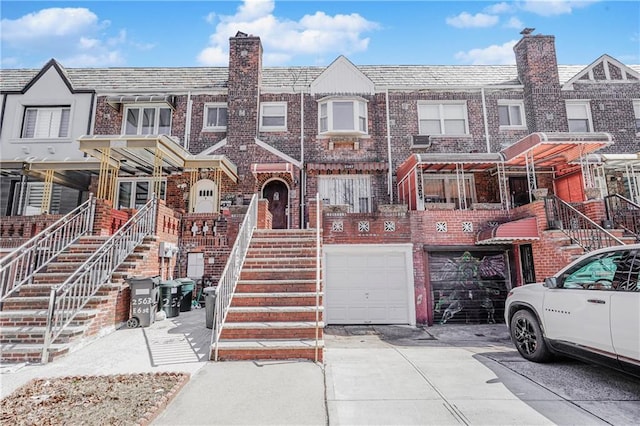 2567 E 6th St, Brooklyn, NY 11235 - multi unit property featuring driveway, a chimney, brick siding, a garage, and a high end roof