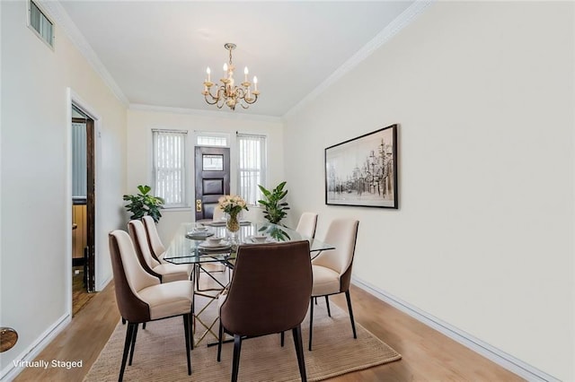 2567 E 6th St, Brooklyn, NY 11235 - dining area with a chandelier, wood finished floors, crown molding, and baseboards