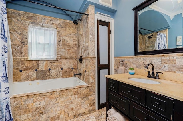 full bathroom featuring vanity, ornamental molding, tiled shower / bath combo, and tile walls