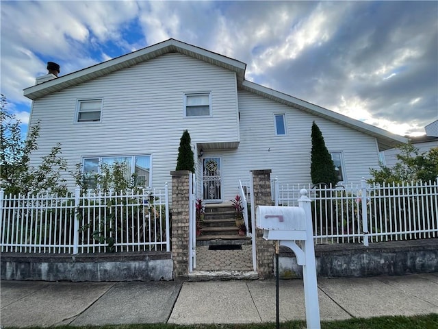 view of front of property featuring fence