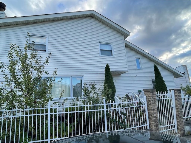 view of side of property featuring fence