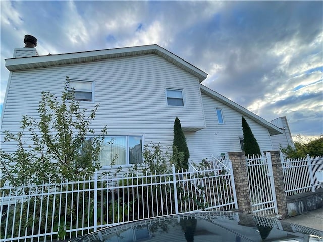 view of property exterior featuring fence