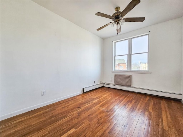 empty room featuring baseboards, a ceiling fan, and hardwood / wood-style flooring