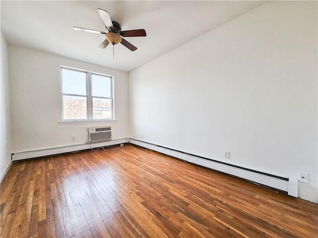 spare room with ceiling fan, a baseboard radiator, hardwood / wood-style flooring, and a wall mounted air conditioner