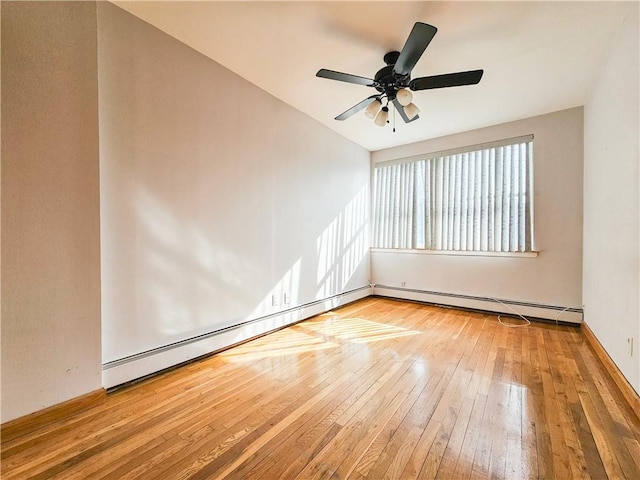 empty room with ceiling fan, baseboard heating, and hardwood / wood-style flooring