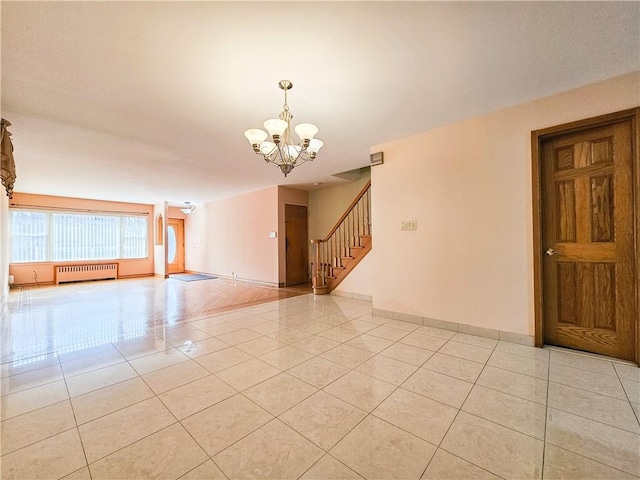 empty room featuring a notable chandelier, radiator, baseboards, light tile patterned floors, and stairway