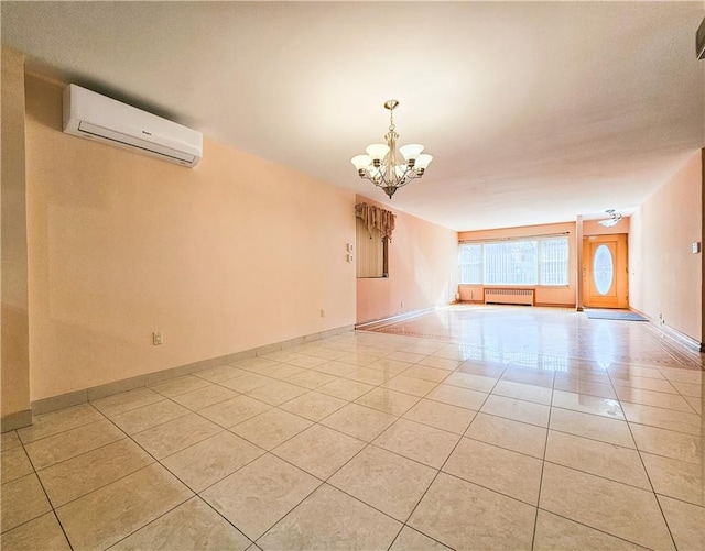 spare room featuring baseboards, a notable chandelier, a wall unit AC, and light tile patterned floors