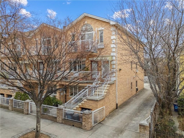 8719 Bay 16th St Unit 3A, Brooklyn, NY 11214 - view of building exterior featuring a fenced front yard and stairway
