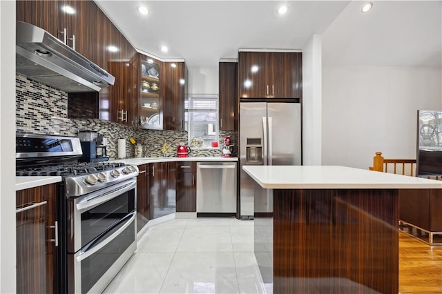 8719 Bay 16th St Unit 3A, Brooklyn, NY 11214 - kitchen with stainless steel appliances, under cabinet range hood, light countertops, backsplash, and recessed lighting