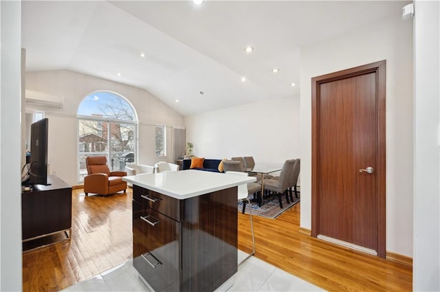kitchen featuring open floor plan, modern cabinets, a kitchen island, and vaulted ceiling