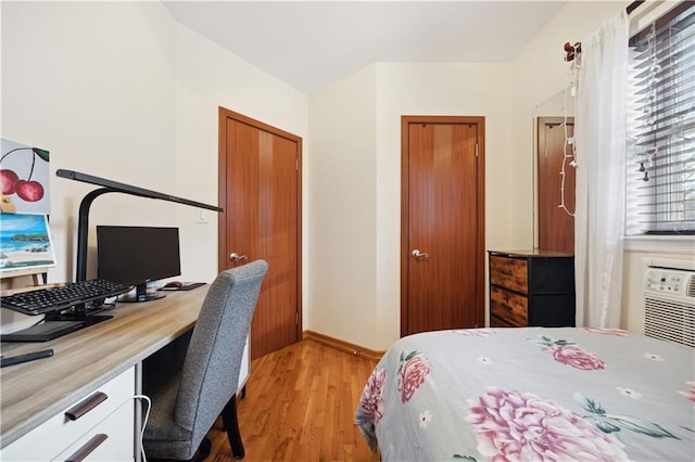 bedroom featuring baseboards, a closet, and light wood-style flooring