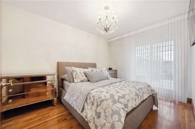 8719 Bay 16th St Unit 3A, Brooklyn, NY 11214 - bedroom featuring wood finished floors and a chandelier