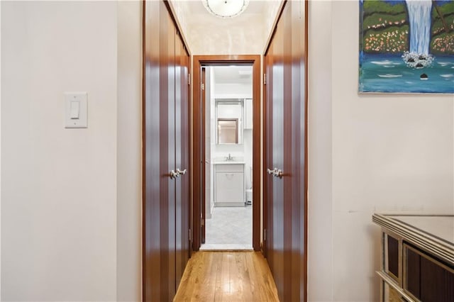 corridor with light wood-type flooring
