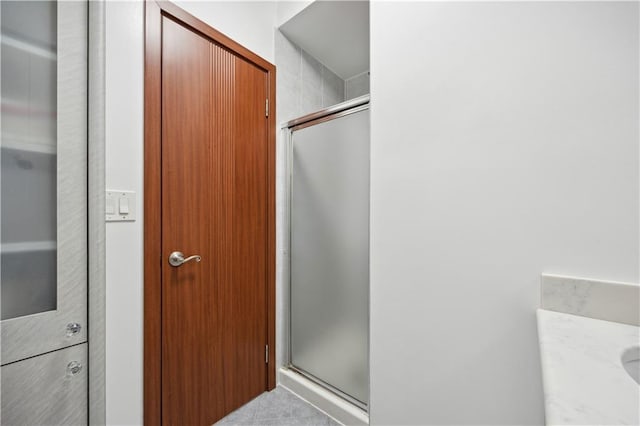 bathroom with a stall shower and vanity