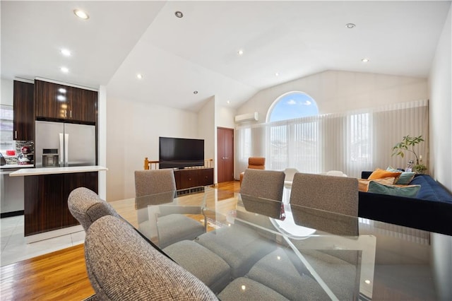 dining room featuring recessed lighting, lofted ceiling, and an AC wall unit