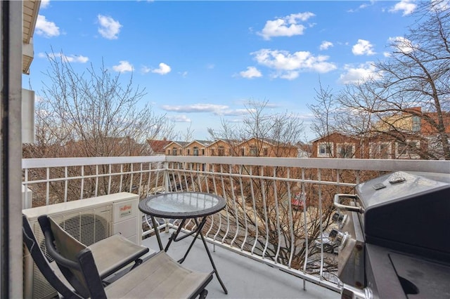 balcony featuring ac unit and a grill