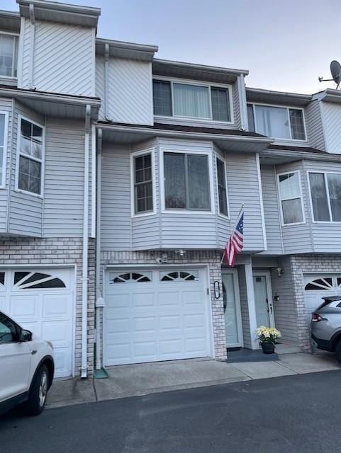 20 Linda Ln, Staten Island, NY 10312 - multi unit property featuring brick siding, a garage, and driveway