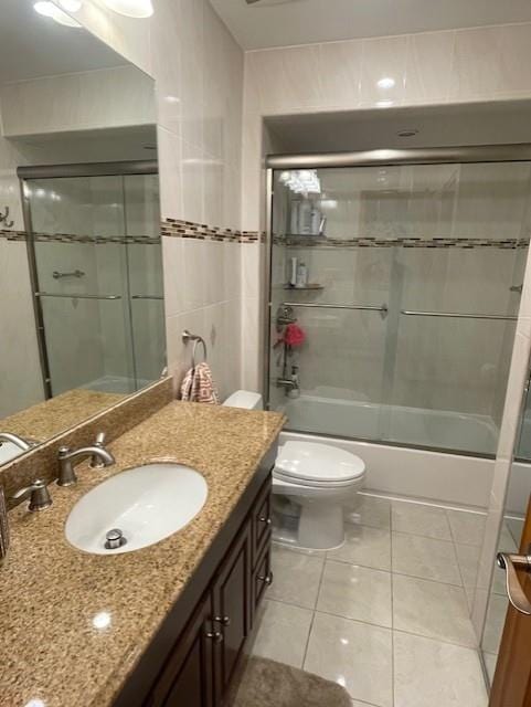 20 Linda Ln, Staten Island, NY 10312 - full bath with tile patterned flooring, enclosed tub / shower combo, toilet, and vanity