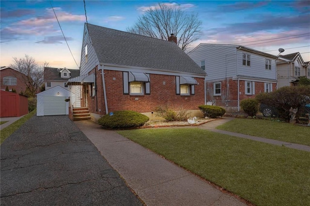 95 Bryson Ave, Staten Island, NY 10302 - view of front of property with brick siding, an outdoor structure, roof with shingles, a garage, and a chimney