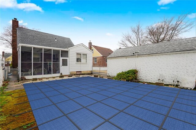 95 Bryson Ave, Staten Island, NY 10302 - back of property featuring a sunroom, fence, and a chimney
