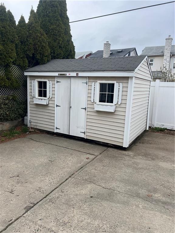 view of shed featuring fence