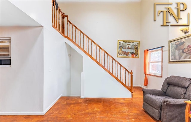 661 E 103rd St, Brooklyn, NY 11236 - stairs with wood finished floors, a high ceiling, and baseboards