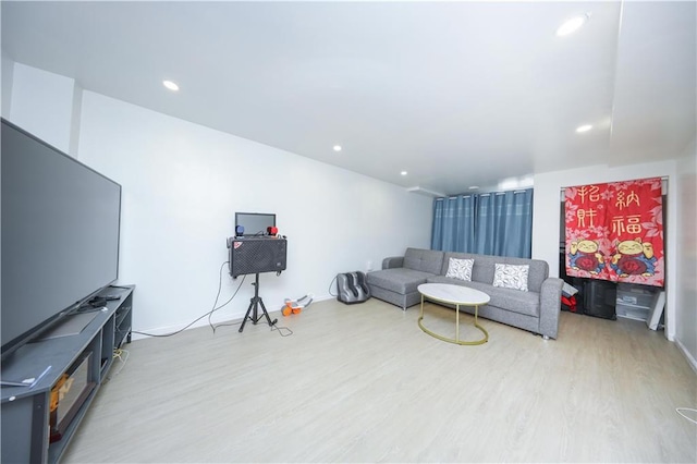 living area featuring wood finished floors and recessed lighting