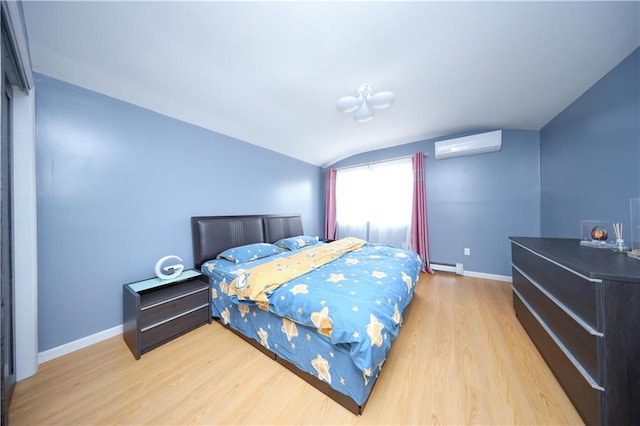 bedroom with vaulted ceiling, a wall mounted air conditioner, a baseboard heating unit, wood finished floors, and baseboards