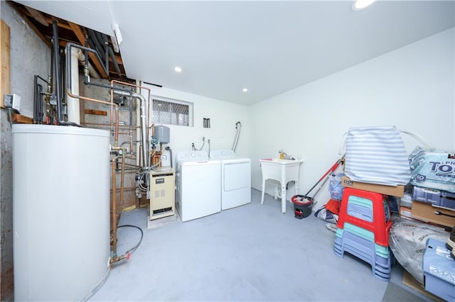 below grade area with separate washer and dryer, water heater, a heating unit, recessed lighting, and a sink
