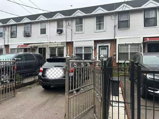 townhome / multi-family property with cooling unit and fence