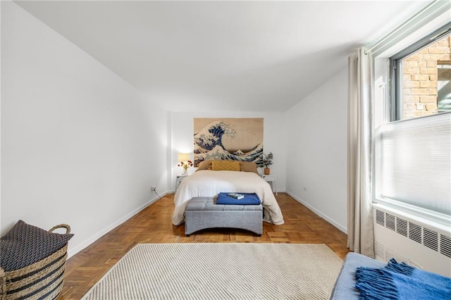 bedroom featuring radiator heating unit and baseboards