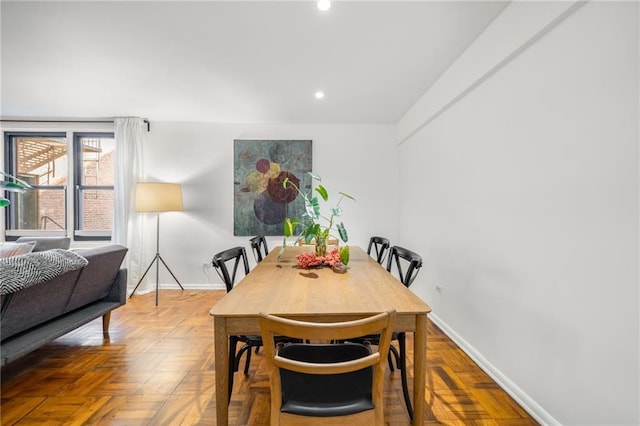 dining room featuring baseboards and recessed lighting