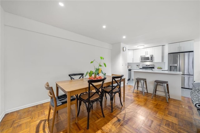 dining area featuring baseboards and recessed lighting
