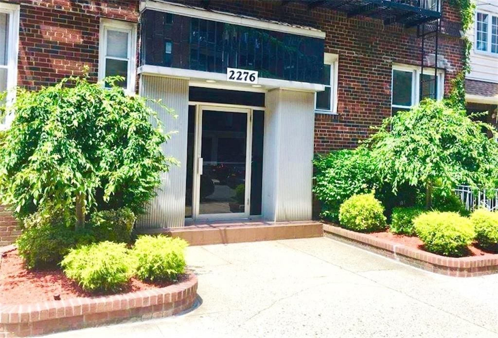 entrance to property featuring brick siding