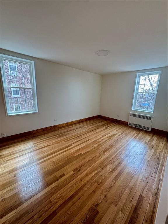 2239 Troy Ave Unit 3N, Brooklyn, NY 11234 - empty room featuring radiator heating unit, wood finished floors, and baseboards