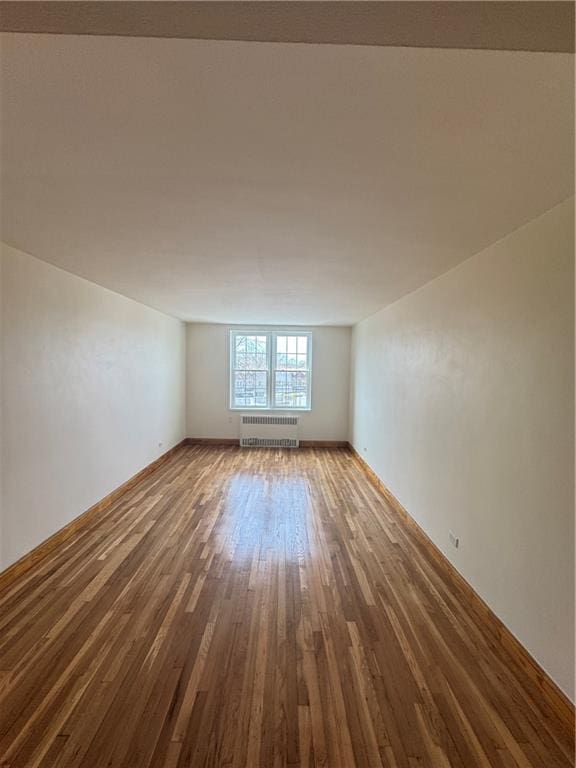 2239 Troy Ave Unit 3N, Brooklyn, NY 11234 - unfurnished room with radiator heating unit, wood finished floors, and baseboards