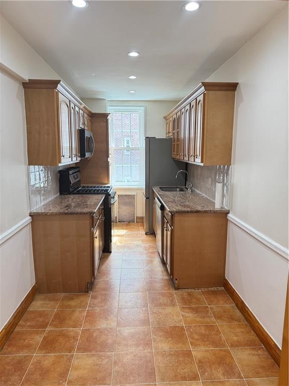 2239 Troy Ave Unit 3N, Brooklyn, NY 11234 - kitchen featuring stainless steel appliances, decorative backsplash, recessed lighting, a sink, and dark stone counters