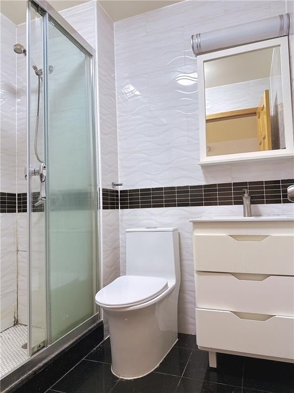 31-47 137th St Unit 4B, Brooklyn, NY 11354 - full bath featuring tile walls, a stall shower, vanity, and tile patterned floors