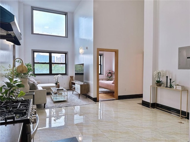 31-47 137th St Unit 4B, Brooklyn, NY 11354 - living room with a high ceiling, electric panel, marble tiled flooring, and healthy amount of natural light