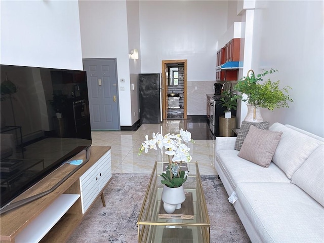 31-47 137th St Unit 4B, Brooklyn, NY 11354 - living area featuring a high ceiling and baseboards