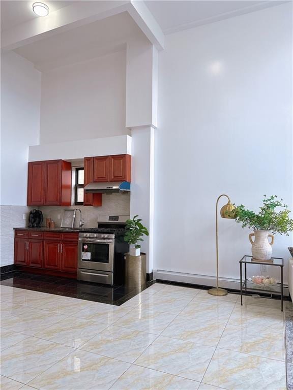 31-47 137th St Unit 4B, Brooklyn, NY 11354 - kitchen featuring stainless steel range with gas cooktop, under cabinet range hood, a high ceiling, dark brown cabinets, and decorative backsplash