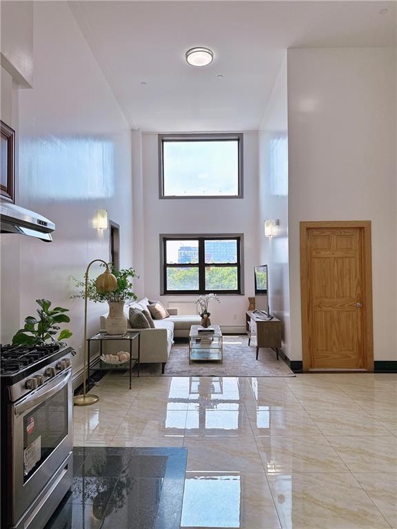31-47 137th St Unit 4B, Brooklyn, NY 11354 - living area with a high ceiling and light marble finish floors