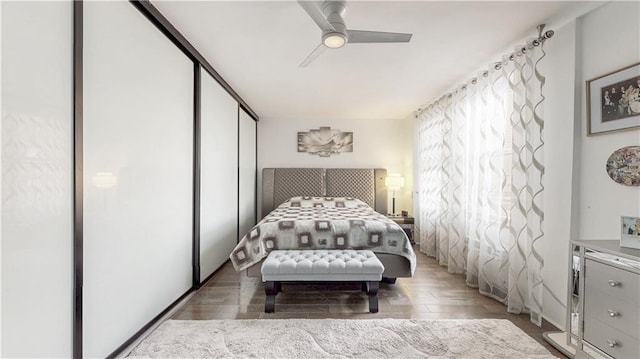 bedroom featuring a closet, wood finished floors, and a ceiling fan